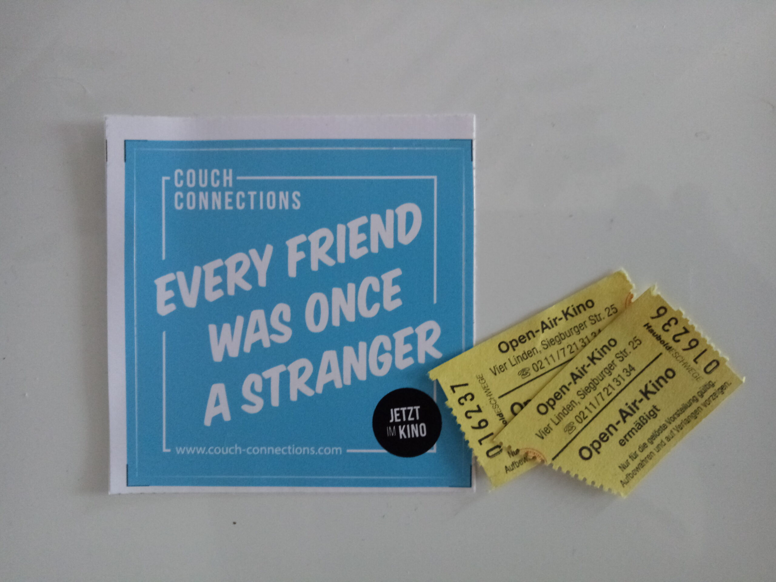 Kinotickets und Aufkleber "Every Friend was once a Stranger"