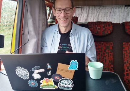 man at a laptop in a camper van
