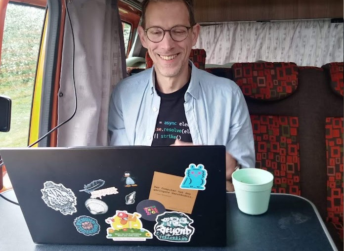 man at a laptop in a camper van