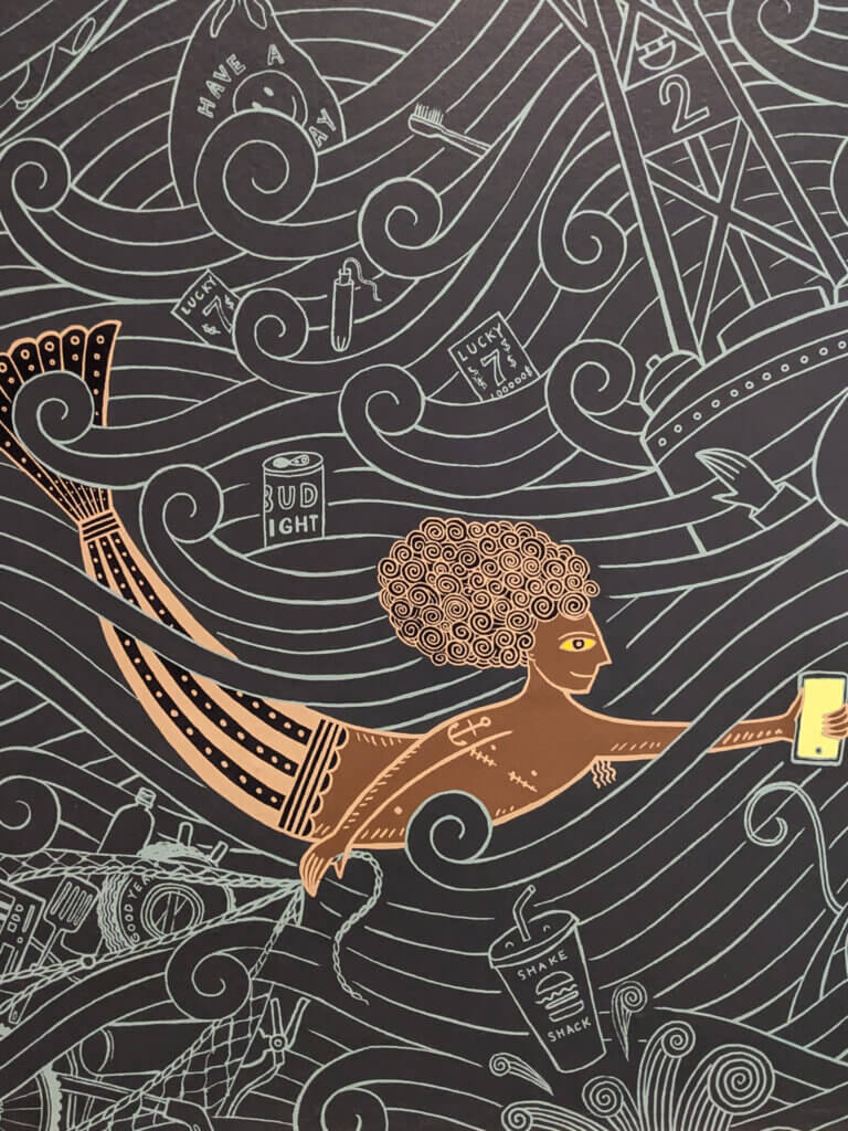mural of a mermaid with smartphone in hand
