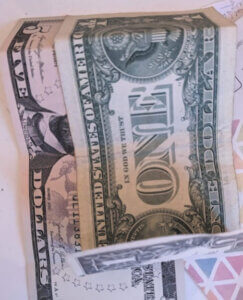 ONE dollar bill on top of a five dollar bill